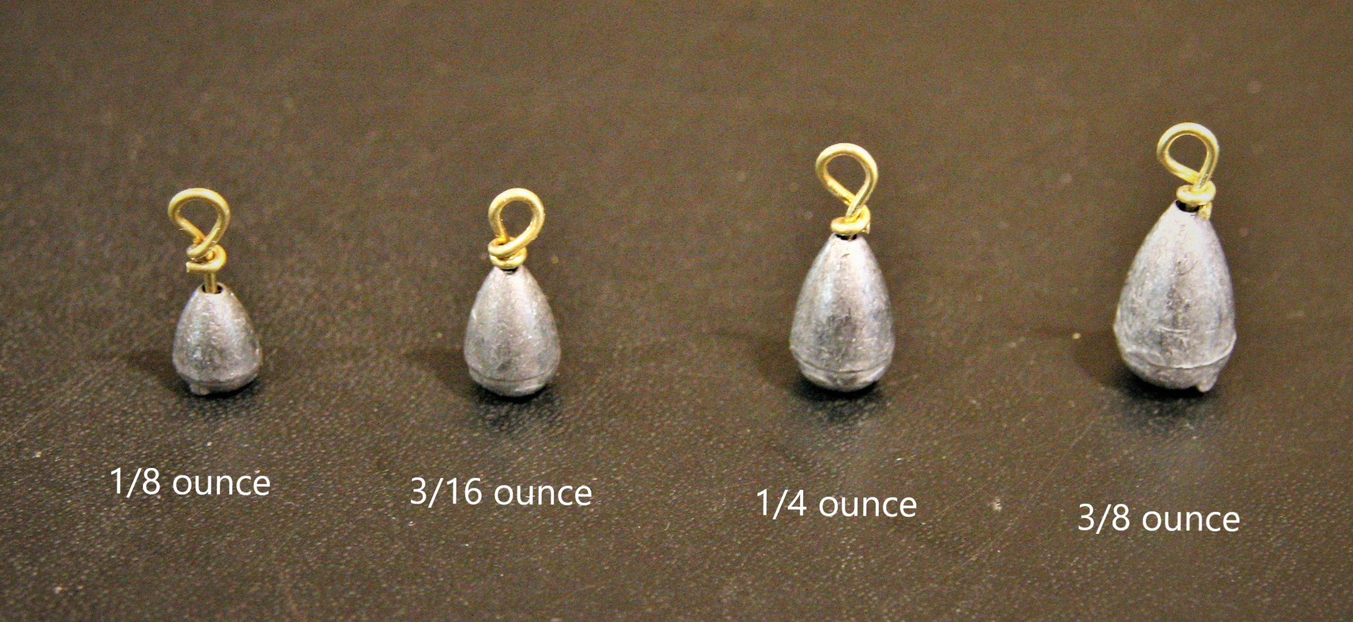 Four different bell sinkers of different weights: 1/8-ounce, 3/16-ounce, ¼-ounce, and 3/8-ounce